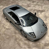 Silver Lamborghini diecast model car, front three-quarter view with clear headlights