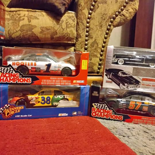 Boxed diecast racing car collectibles with numbered cars and blister packaging