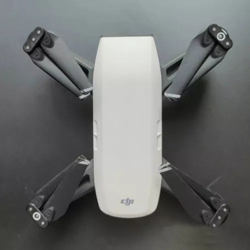 White quadcopter drone with four folded arms and visible rotor guards