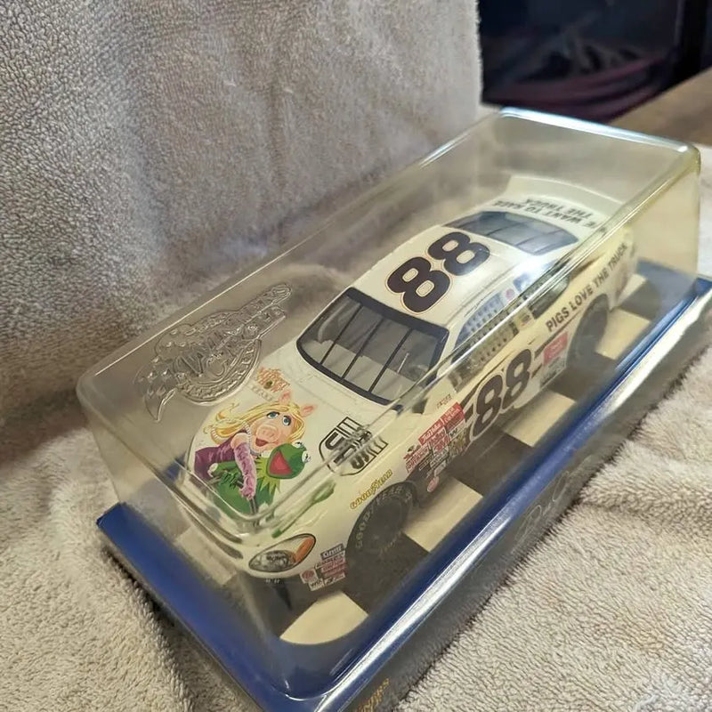 Cream diecast race car with number 88, Miss Piggy graphics, in clear display box
