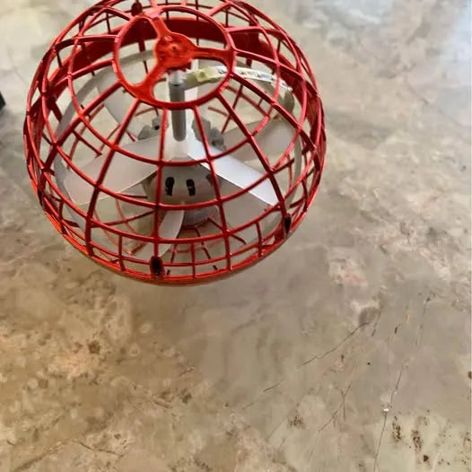 Red spherical ball drone with wire cage, central hub, and propeller guard