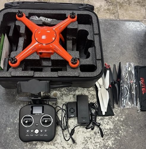 Orange quadcopter drone kit with controller and accessories in hard case