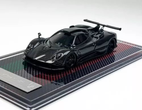 Black racing sports diecast model car on display base, front 3/4 view