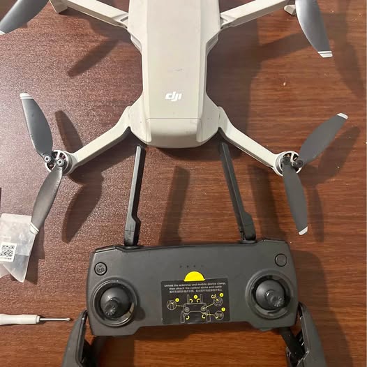 DJI Mavic Mini drone, gray body with front sensors and four folding propellers