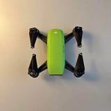 DJI Spark drone with lime green body and four black foldable propellers