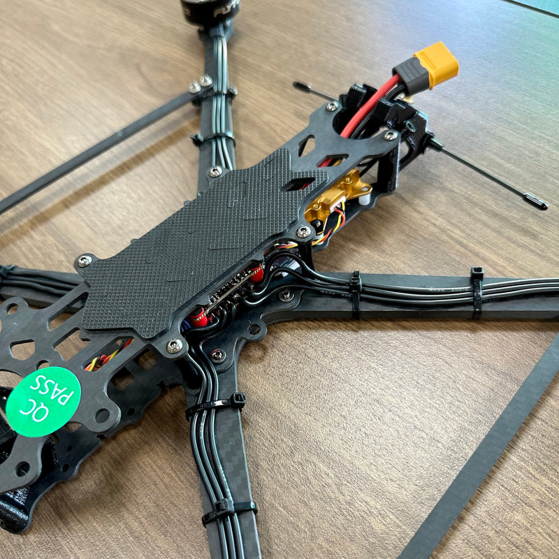 FPV drone frame with mounted camera bracket and exposed wiring