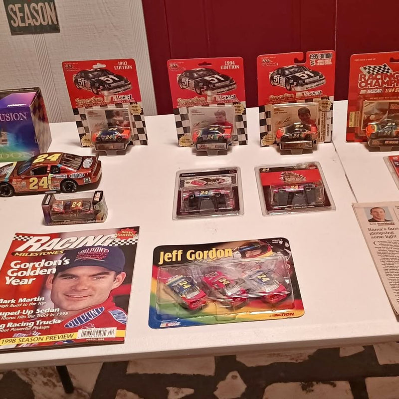 Diecast car collectibles in retail boxes, including a blister pack with race cars