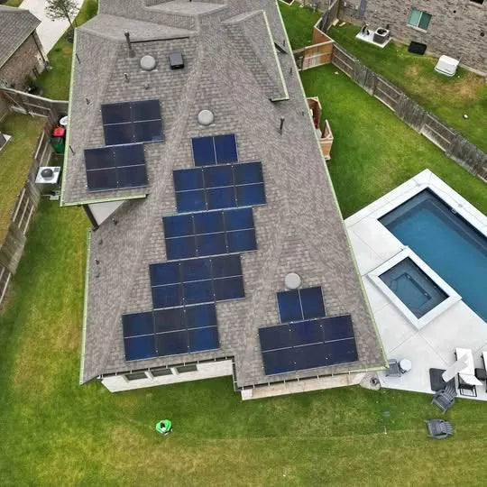 Solar panel roof from overhead angle, with outdoor pool and patio below