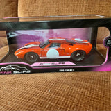Orange Ford GT40 Mk1 diecast model car with white racing stripe, in display box.