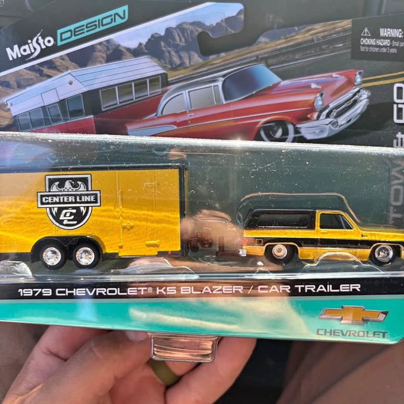 Diecast car with yellow trailer and red 1979 Chevrolet K5 Blazer model