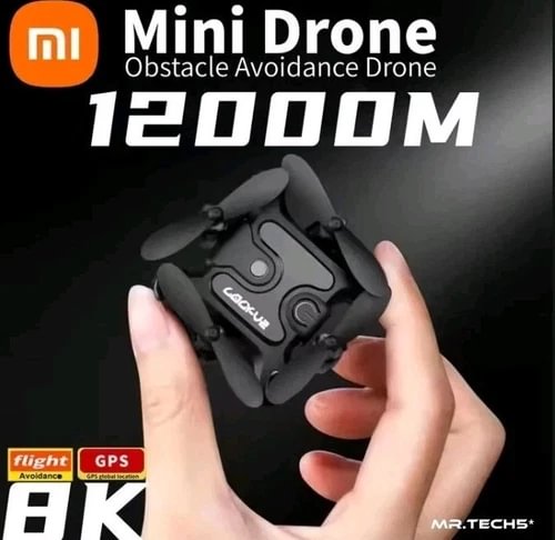 Mini drone quadcopter with foldable propellers, held in hands, black body