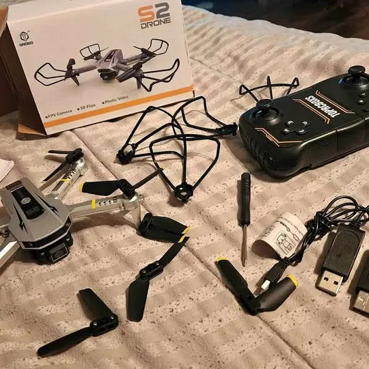 Foldable quadcopter drone with controller, spare batteries, and USB charging cable kit