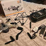 Foldable quadcopter drone with controller, spare batteries, and USB charging cable kit