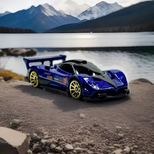 Diecast racing car model, blue and black with gold wheels, front three-quarter view