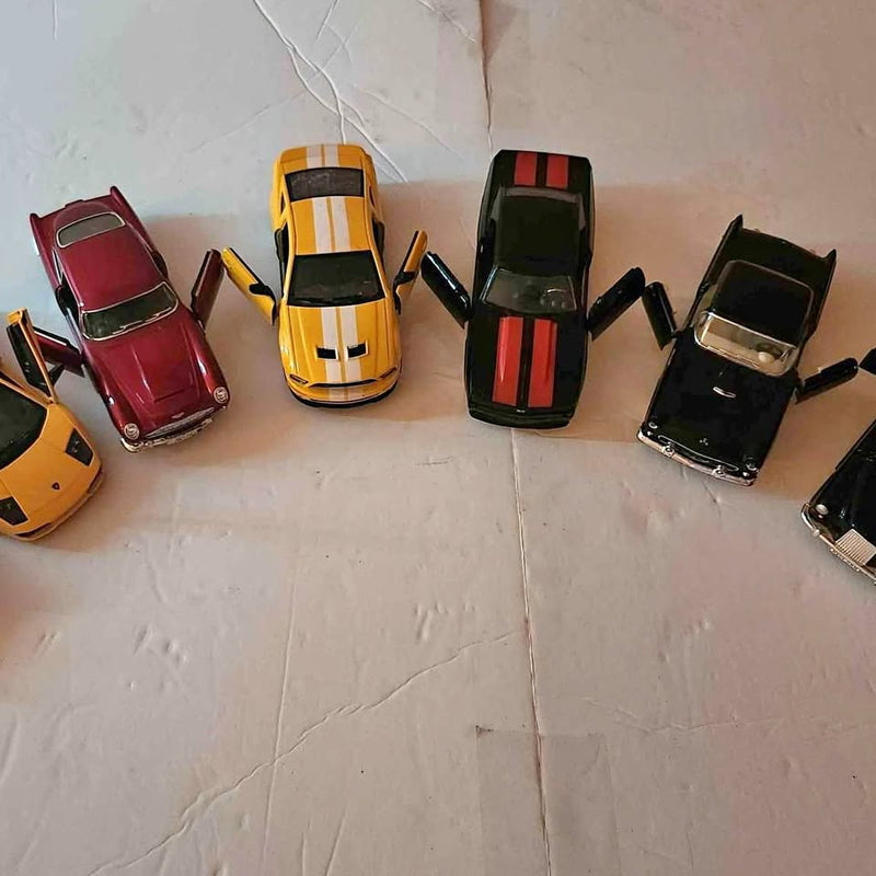 Diecast model cars assortment, red yellow and black vehicles with visible stripes.