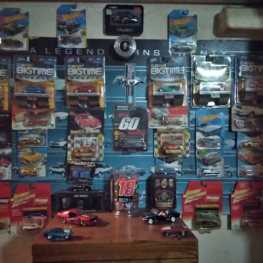 Collectible diecast car set with boxed cars and loose miniature cars on display