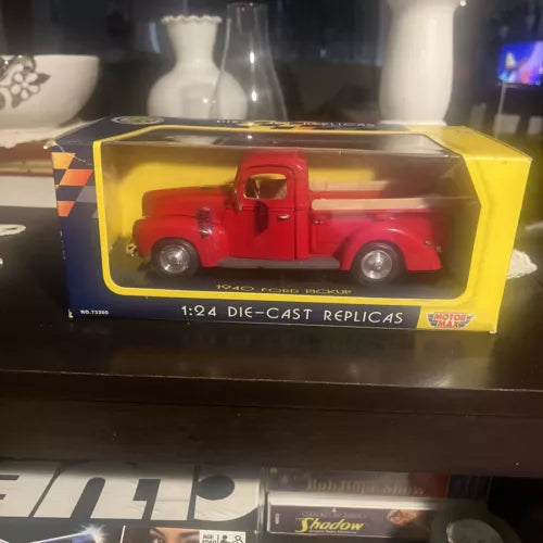 Red 1:24 die-cast pickup truck model in display box