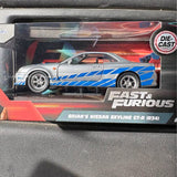 Die-cast sports car in silver with blue racing stripes and orange accents