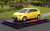 Yellow diecast model car on display base, front three-quarter view