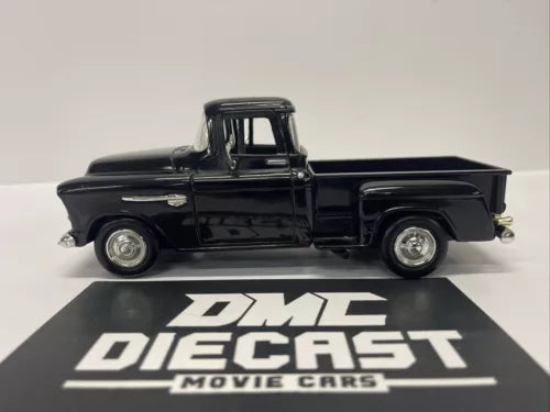 Black 1/24 diecast step side pickup truck with open bed, side view