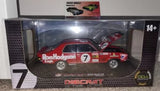 Red and white diecast race car model in display box, number 7, DDA