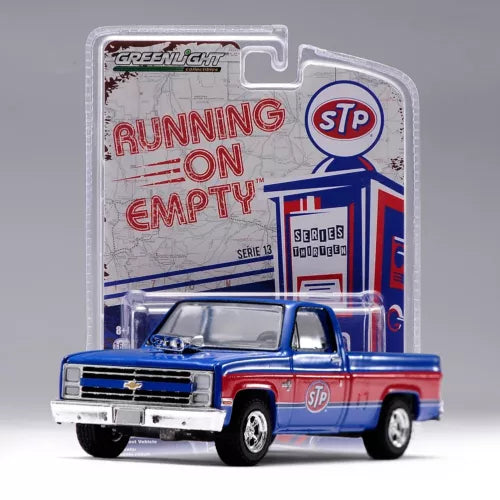 Blue diecast Chevrolet Silverado pickup truck with STP decal, front 3/4 view