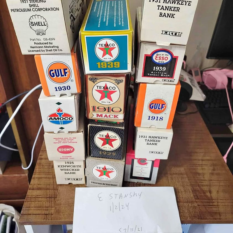 Set of labeled diecast bank trucks in display boxes with oil logos