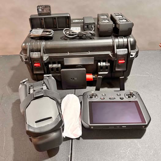Drone controller with touchscreen, charging cables, and protective hard case accessories