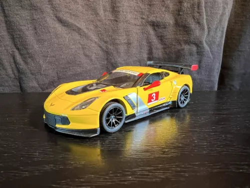 Yellow diecast toy race car with #3 decal, black wheels, front 3/4 view