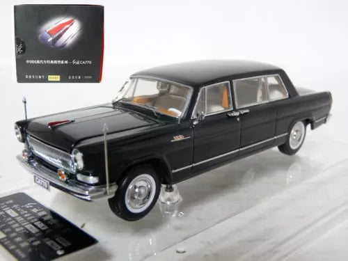 Black diecast limousine model car with chrome grille and red stripe on hood