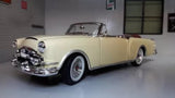 Cream open-top convertible diecast car model, 1:24 scale, chrome front details