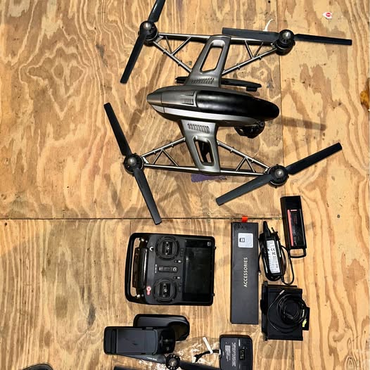 4K drone with camera gimbal, transmitter, and spare batteries laid out