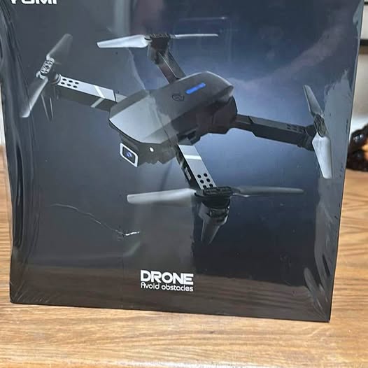 Drone in retail box packaging, four-blade quadcopter shown on front