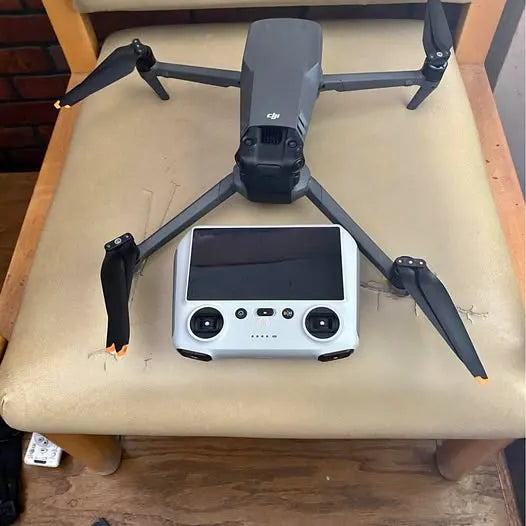 DJI drone with remote controller, front view and folded propellers