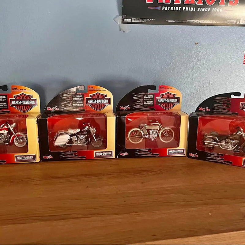 Harley Davidson diecast model cars in retail boxes, three packaged vehicles