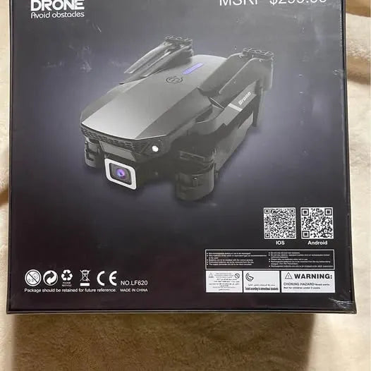 Foldable quadcopter drone with camera, shown on retail box