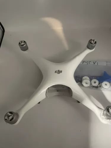 White DJI Phantom 4 Pro quadcopter drone body with four propeller mounts