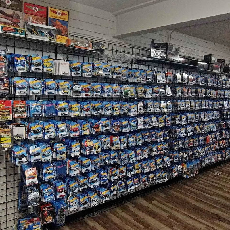 Diecast toy car blister packs on display, multiple models in blue packaging