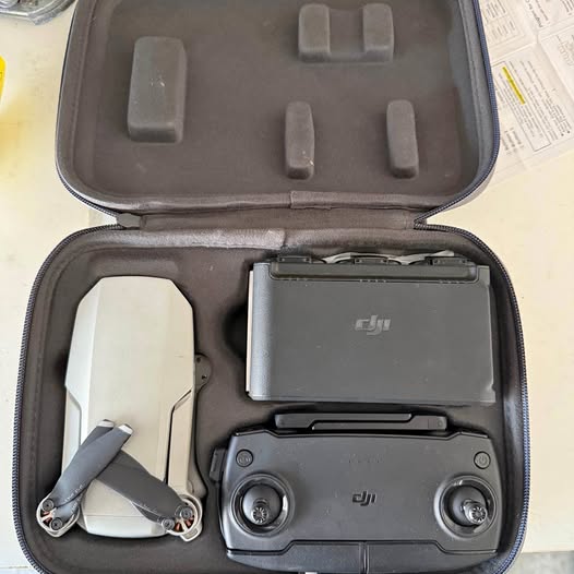 DJI compact drone with remote in hard travel case, dark gray