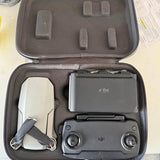 DJI compact drone with remote in hard travel case, dark gray