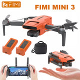 Orange 3-axis gimbal camera drone kit with quadcopter, batteries, and controller screen.