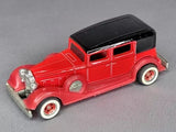 Red 1:64 diecast classic car with black roof and chrome details, red-and-white wheels