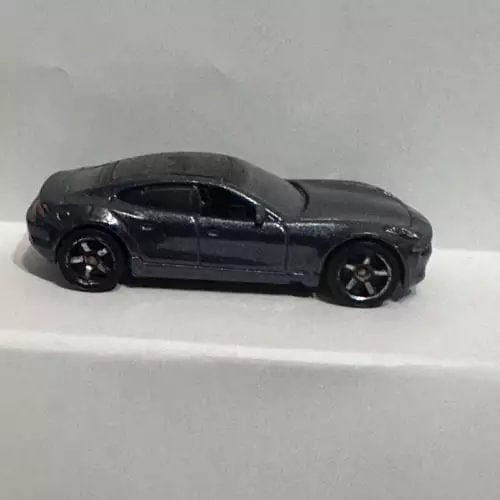 Black Fisker Karma diecast car, side view, detailed wheels and windows