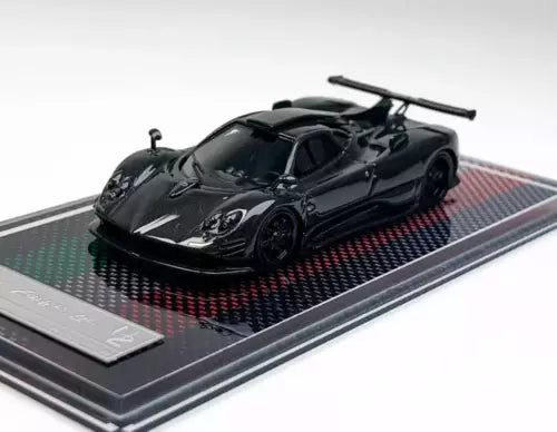 Black 1:64 racing sports diecast model car with display base, front three-quarter view