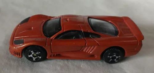 Burnt orange 1:64 diecast model car with black wheels, side view.