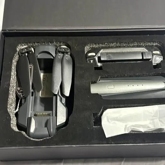 Foldable GPS drone with folded body and prop arms in storage box