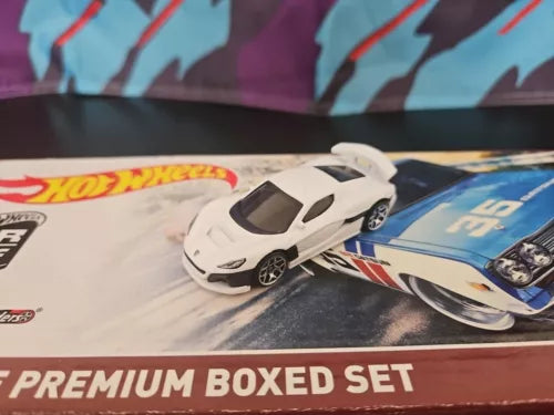 White 1/64 diecast sports car model, side view on blister card