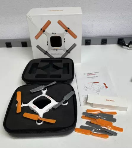 Nano quadcopter drone with orange propellers, in black carrying case and retail box