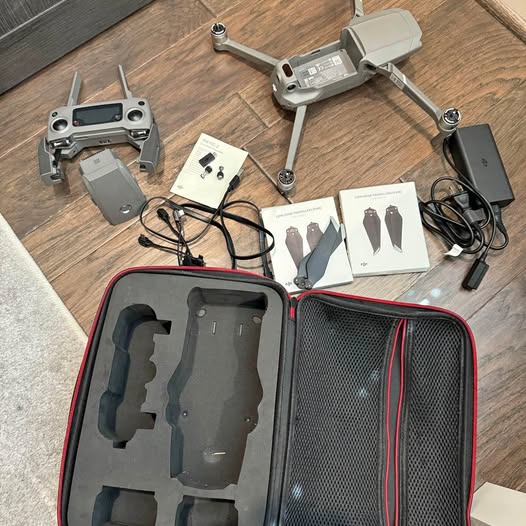 Hard-shell drone case with DJI drone parts, remote, batteries and cables inside