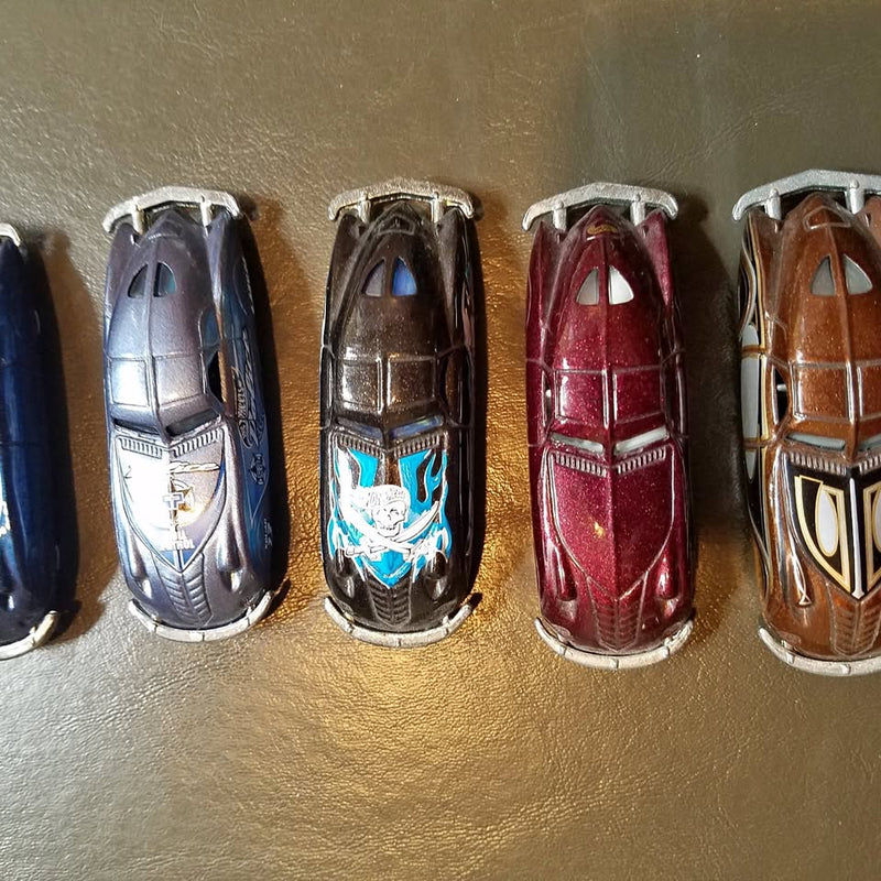 Diecast toy cars, four models in silver, blue, red and brown with detailed body.